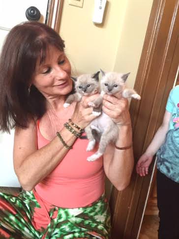 Cheri with two foster kittens. Photo via Cheri.