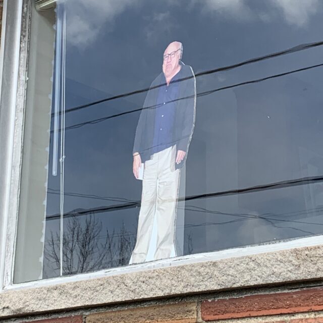 Danny DeVito cutout in a window