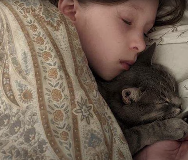 Girl sleeping with cat