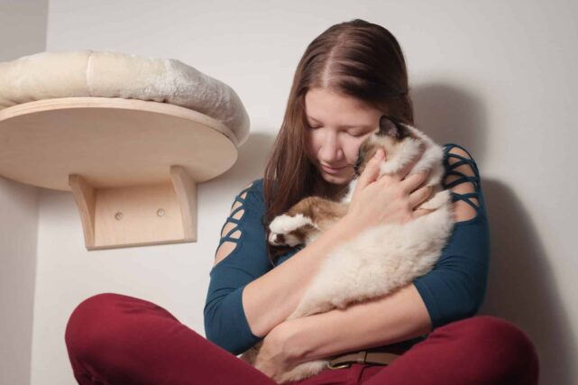 Young Woman Hugging Birman Cat